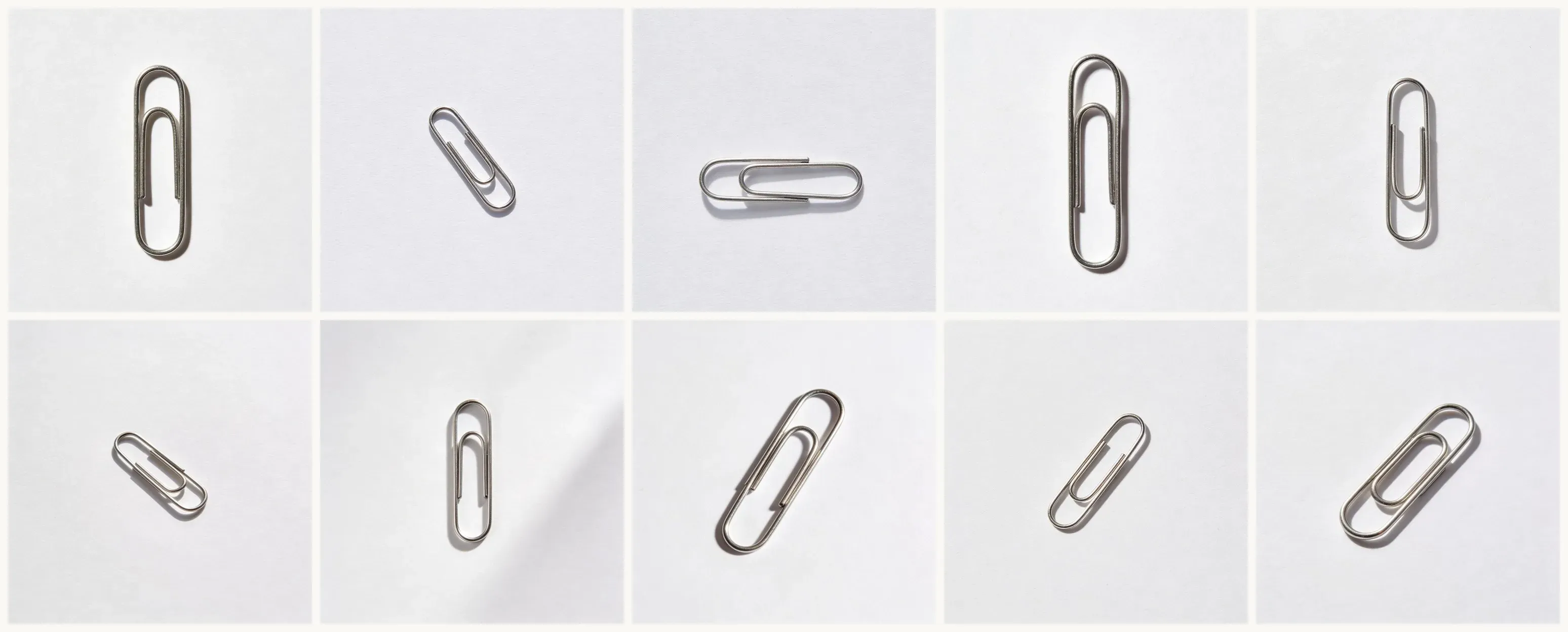 A 5-by-2 grid of ten different paperclip generations on white backgrounds, each from the same prompt run separately, all showing recognizable paperclips with slightly varied orientations and shadow casts.