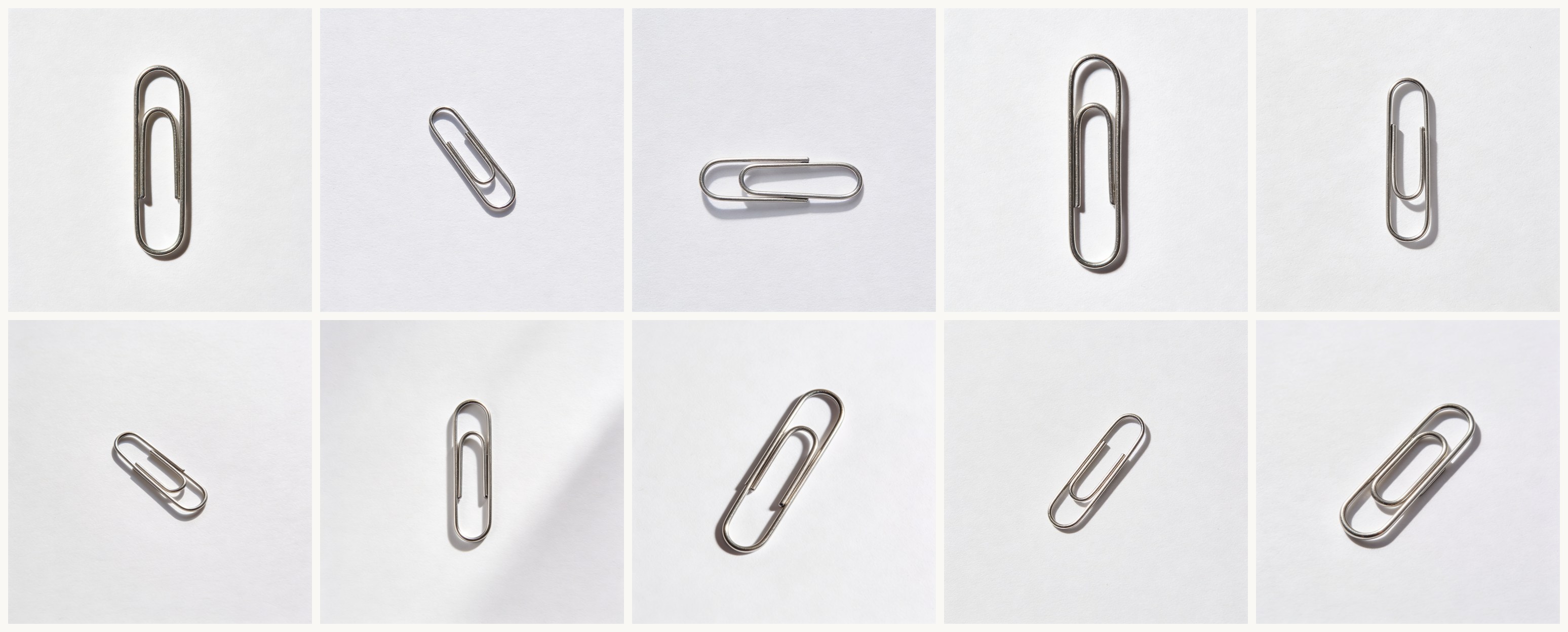 A 5-by-2 grid of ten different paperclip generations on white backgrounds, each from the same prompt run separately, all showing recognizable paperclips with slightly varied orientations and shadow casts.